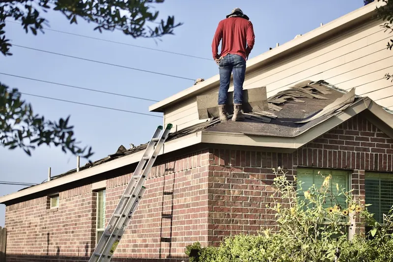 Professional roofer working on a residential roof in Dove Valley Ranch